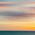 a blurry photo of a sunset over the ocean